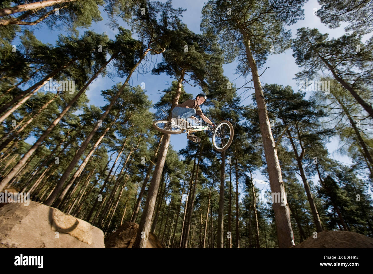 mountain bike dirt jump trick stunt air leap bmx mountain bikes MTB  BMX dirt jumper pulls stunts in trees sick whip youth sport Stock Photo