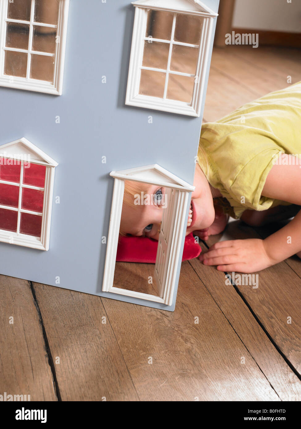 Little girl playing with a doll house Stock Photo - Alamy