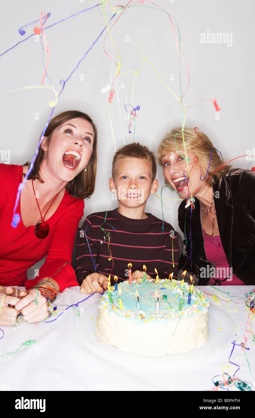 Women and boy with birthday cake Stock Photo