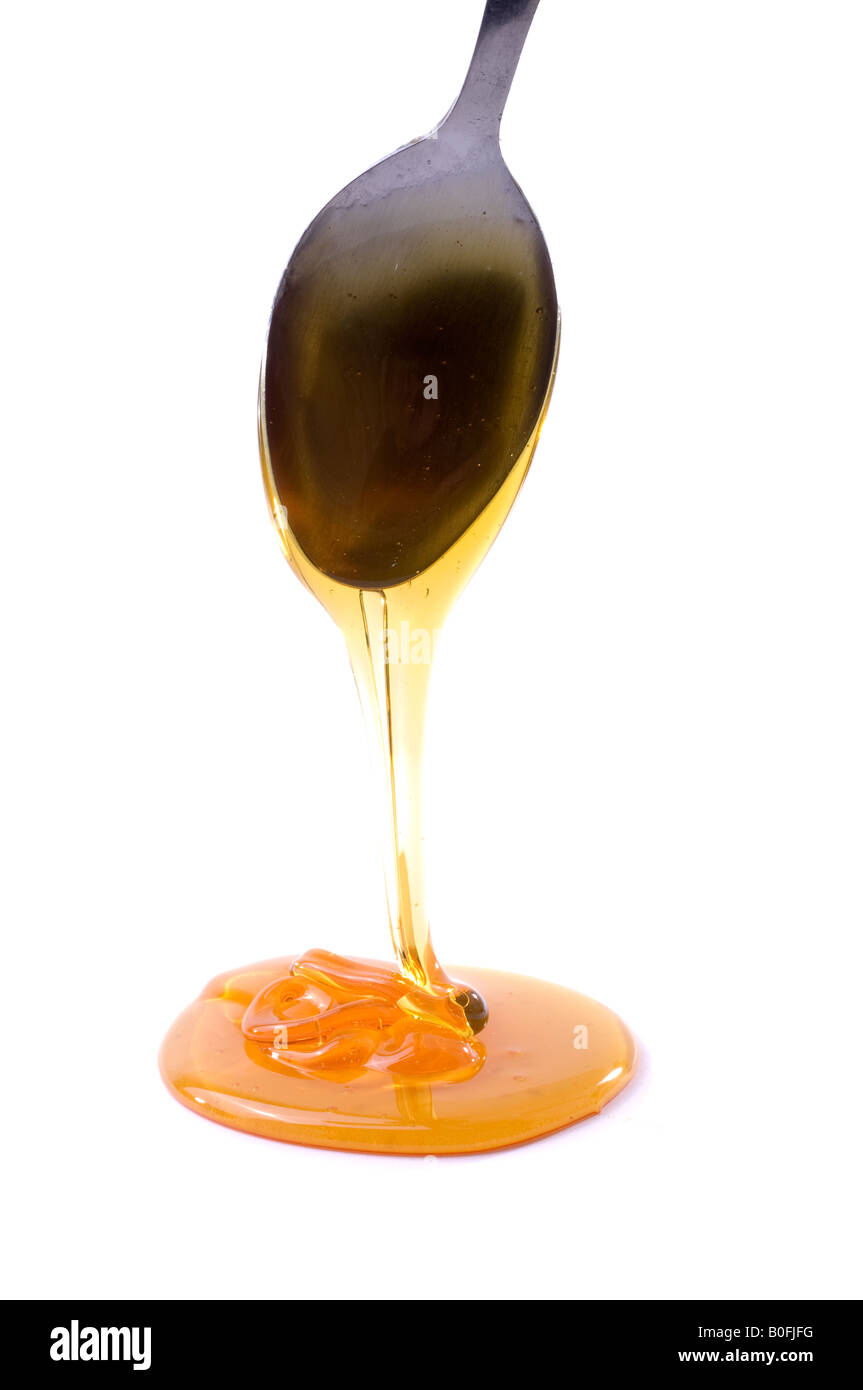 Sticky syrup dripping from a spoon Stock Photo Alamy