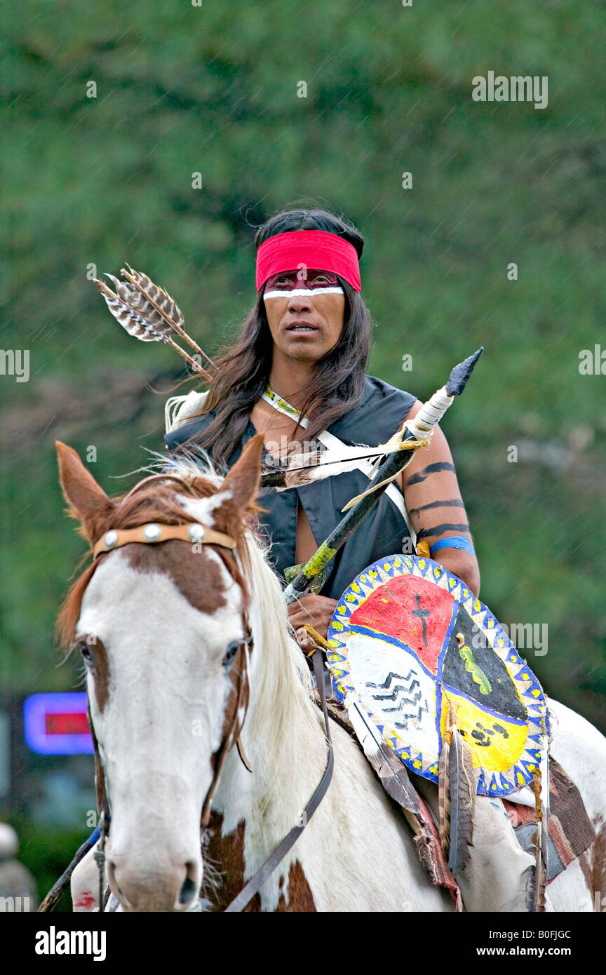 A Native American Indian decorated and dressed in traditional warrior ...