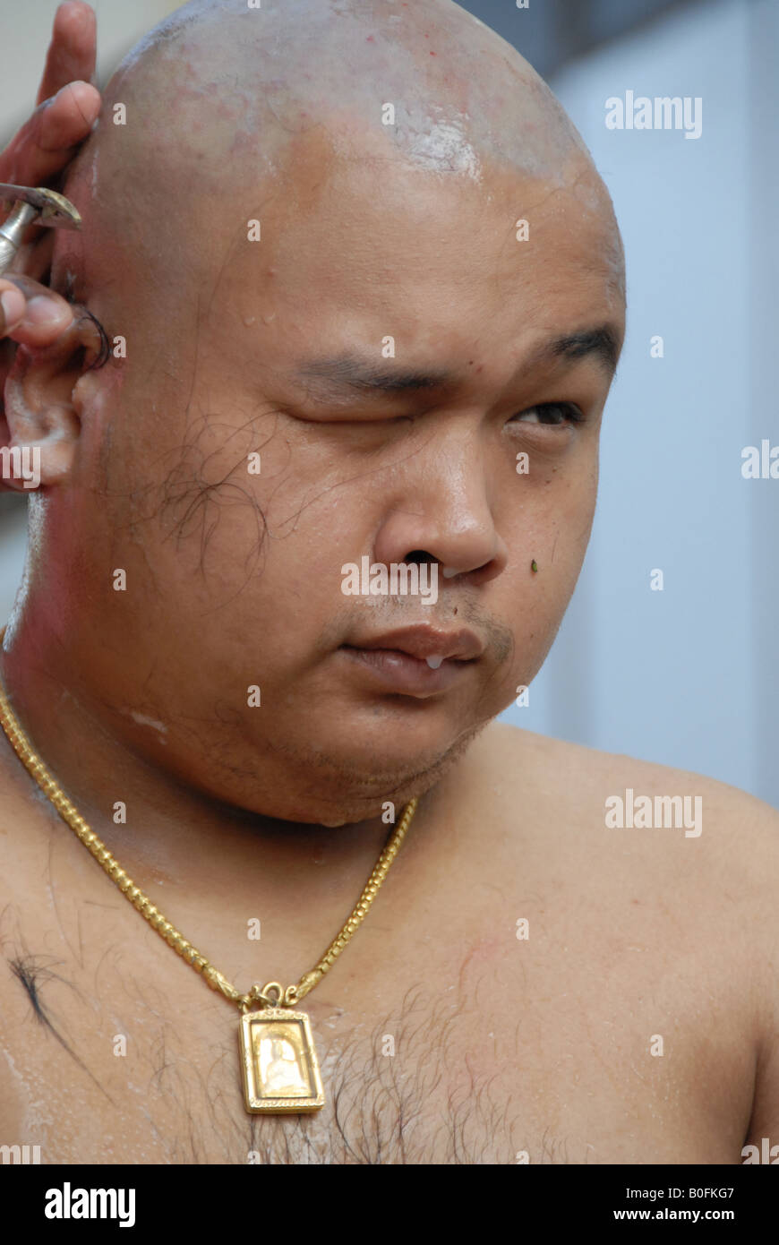 shaving head during buddhist ordination ritual before buddhist ordination ritual , wat bor ,bangkok , thailand Stock Photo