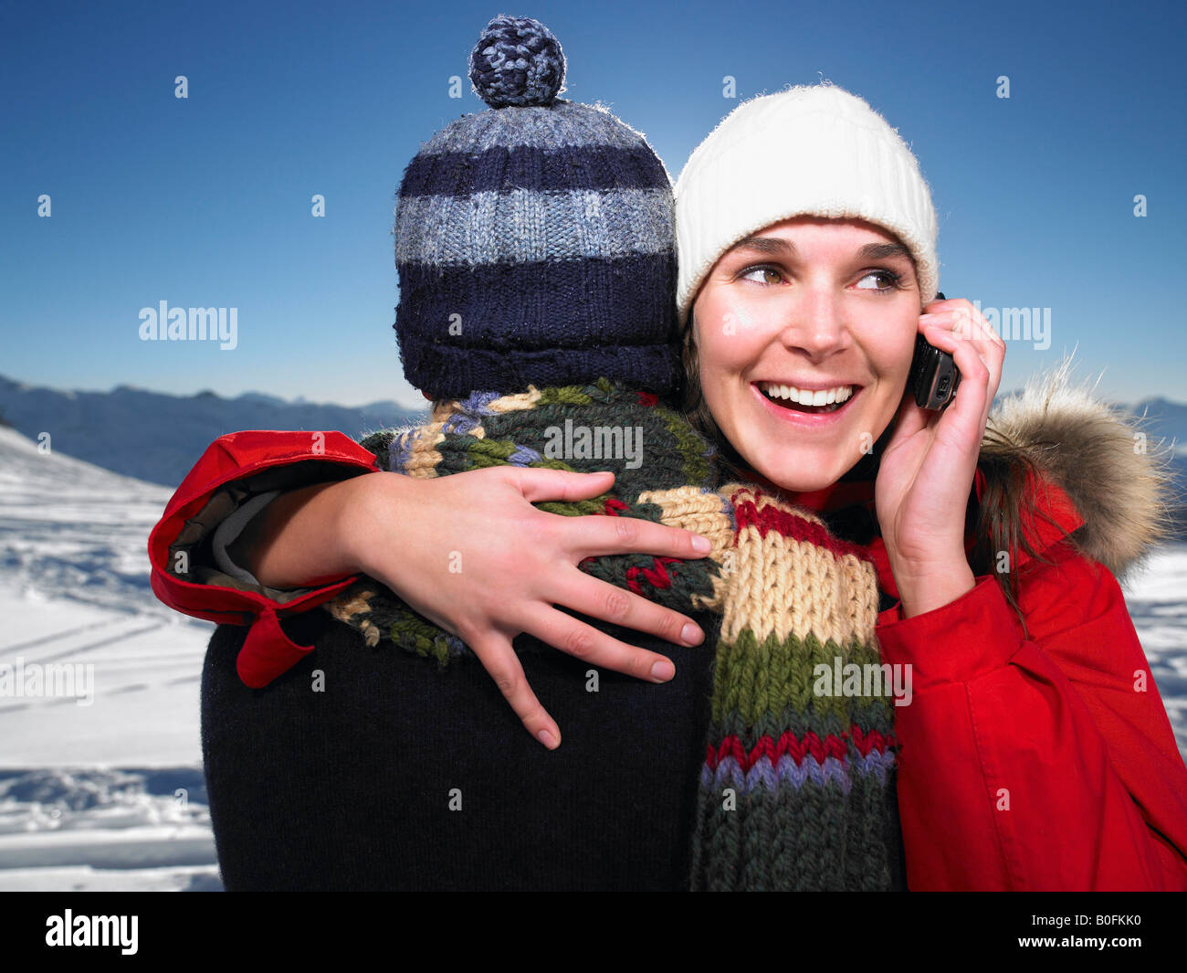 Man hugging woman on phone Stock Photo Alamy