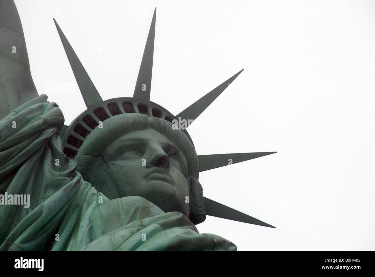 Close-up of the Statue of Liberty, with balance of white and statue. Stock Photo