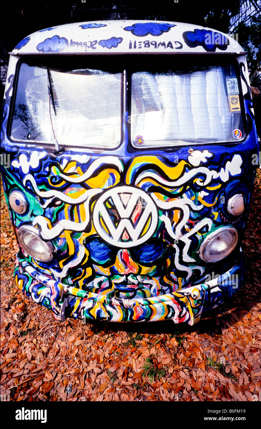 Hippie psychedelic paint job on VW Volkswagen split screen 1960s camper van on autumn fall leaves Stock Photo