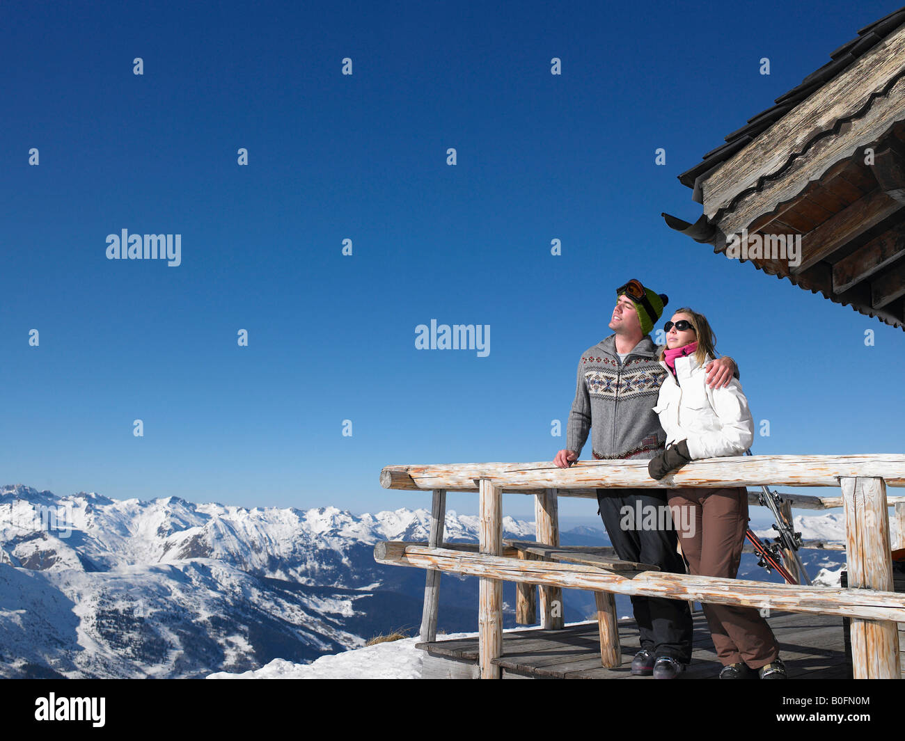 Couple enjoying sun at mountains Stock Photo