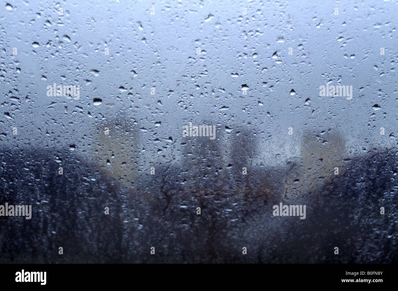 raindrops on skylight with apartment tower blocks behind Stock Photo Alamy
