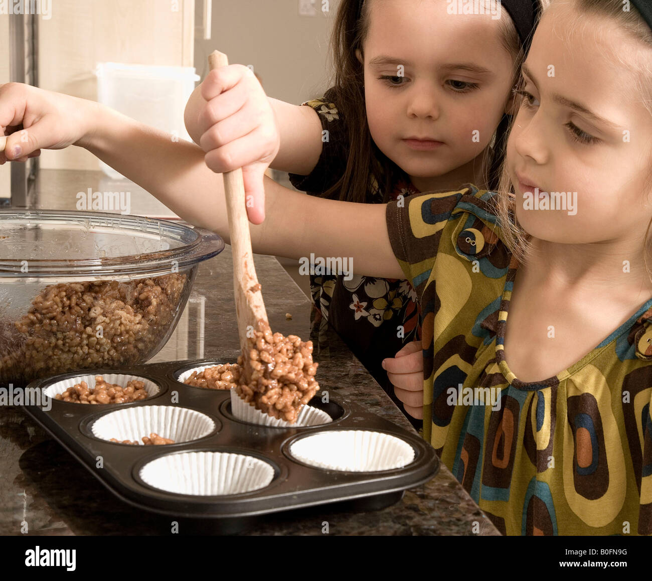 Young girls baking cakes Stock Photo