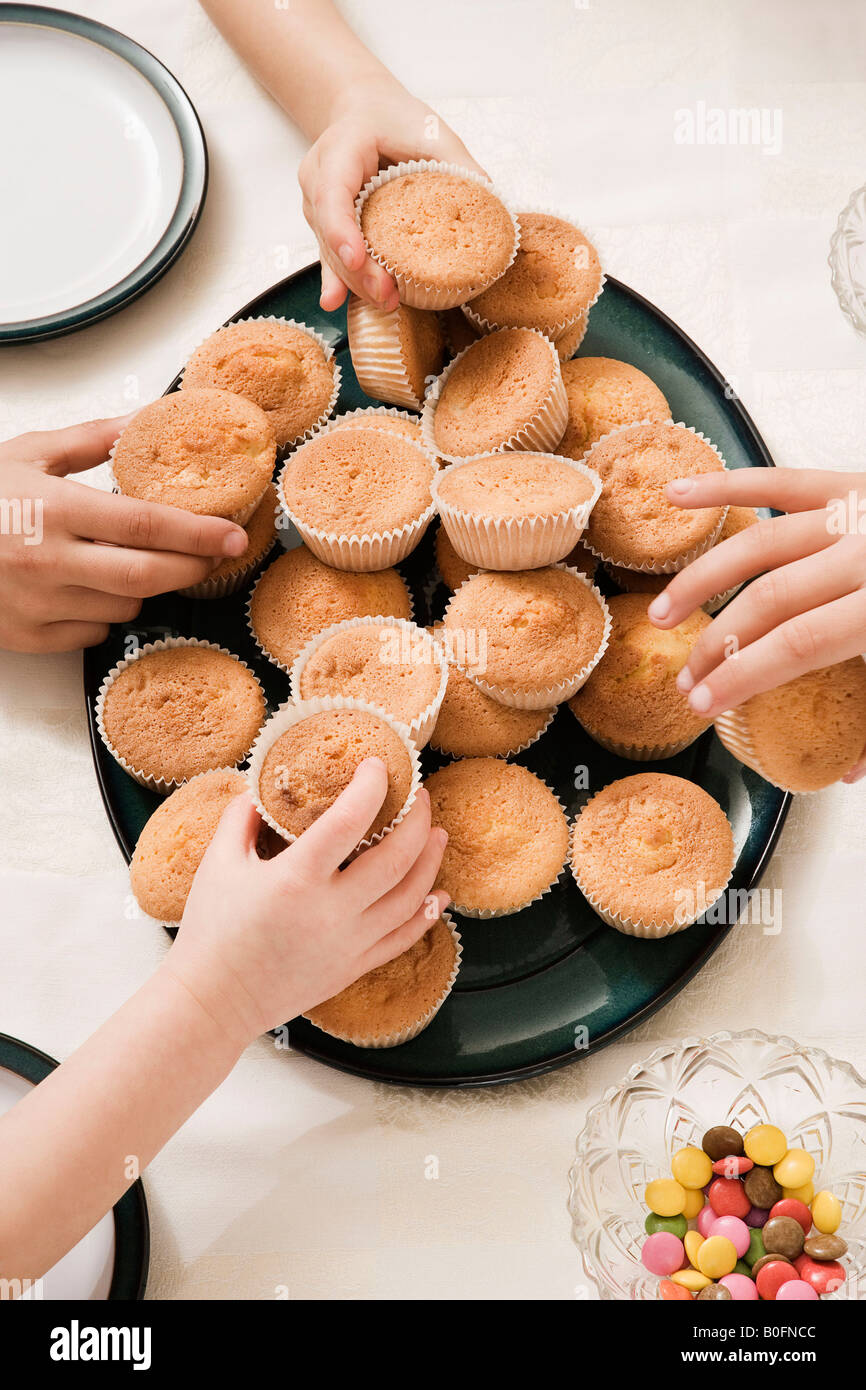 Hands grabbing cakes Stock Photo