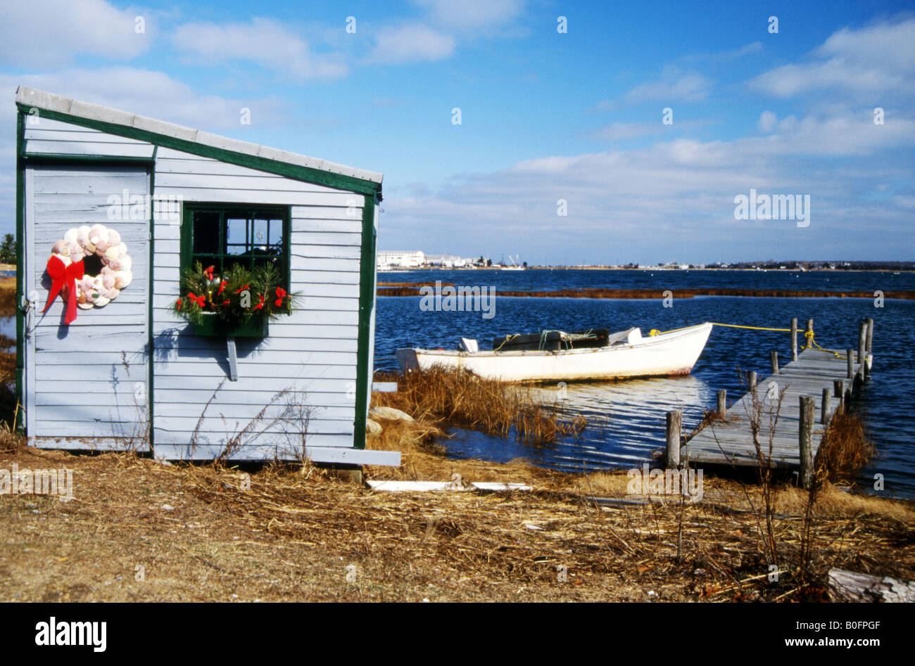 Small lakeside summer beach house with boat tied up outside,near Edgartown,Martha's Vineyard,Massachussetts,U.S.A Stock Photo