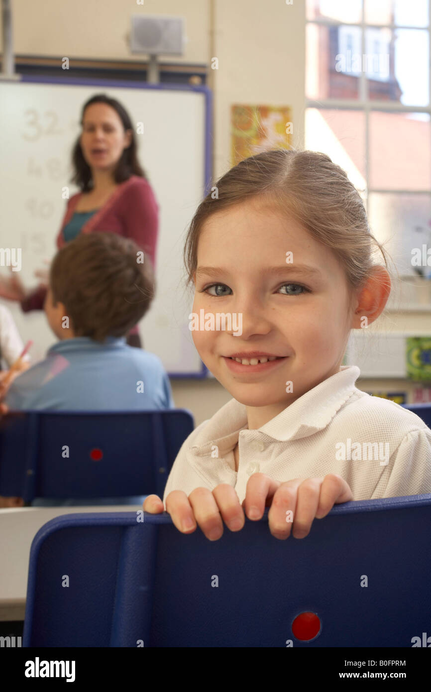Girl looking at camera, in classroom Stock Photo - Alamy