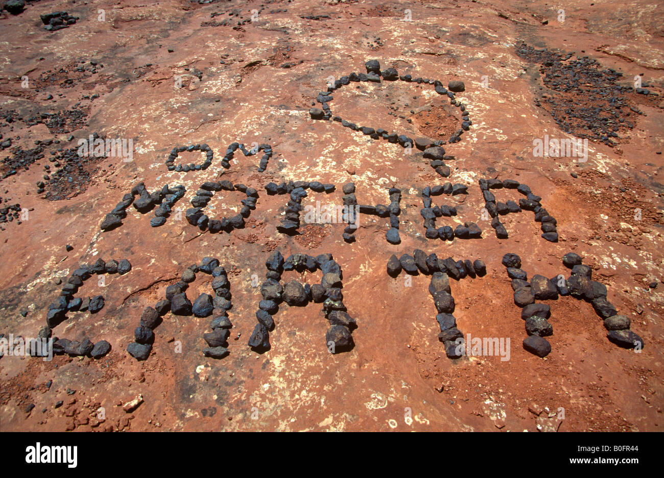 Rocks form the words "OM Mother Earth" in reverence to planet earth near Sedona, Arizona, a center for spiritual vortexes Stock Photo