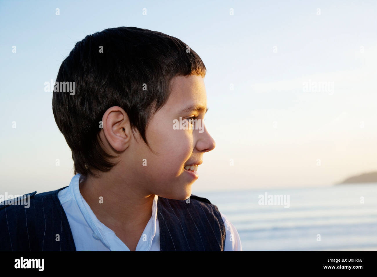 Young boy looking out to sea Stock Photo