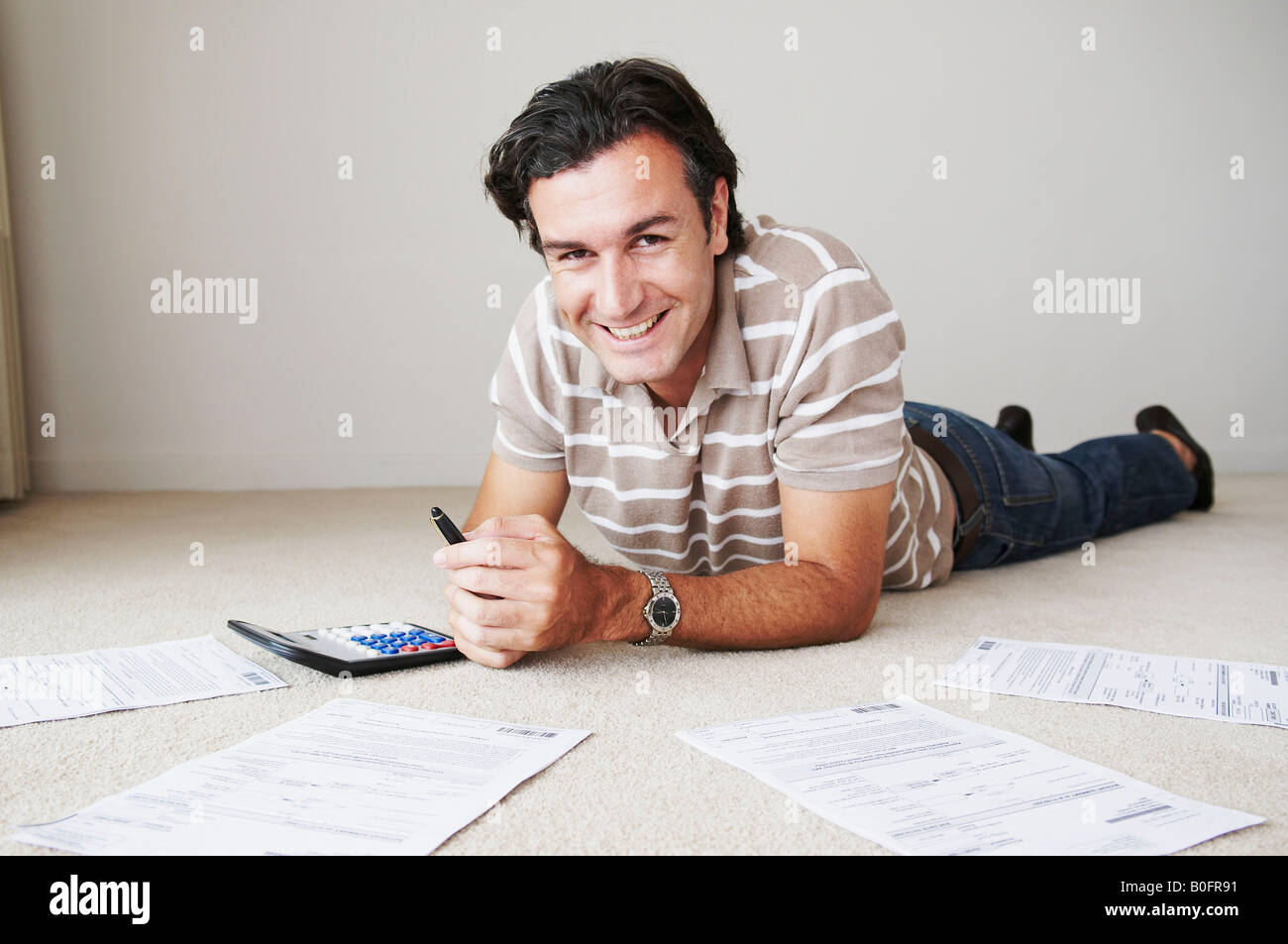 Man works on home finance Stock Photo