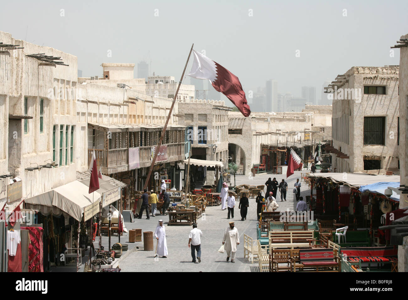 Qatari flag flapping over the Souq Waqif market in Doha, Qatar. Stock Photo