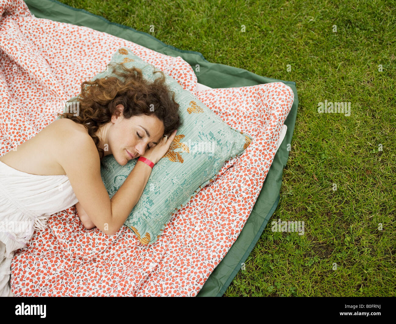 Woman sleeping on blanket outside Stock Photo Alamy