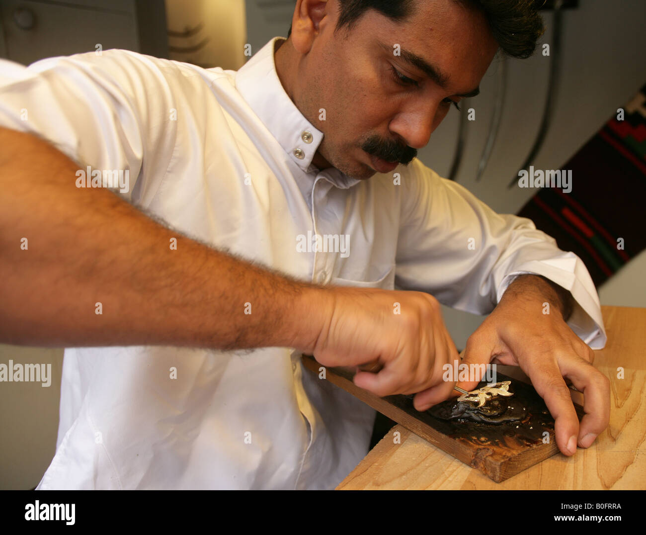 Man carving wood in Doha, Qatar Stock Photo Alamy
