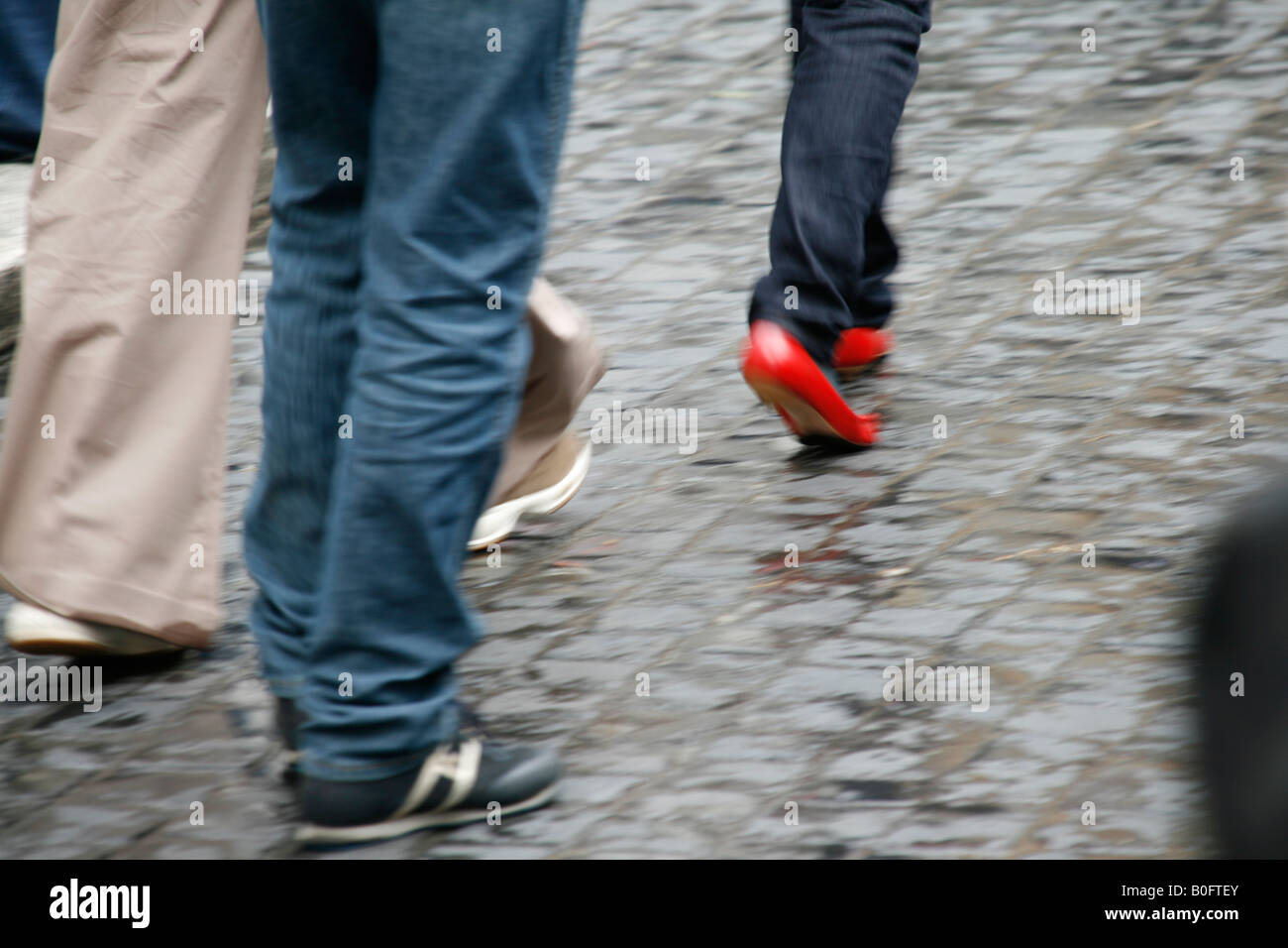 woman wearing red shoes walking in town Stock Photo Alamy
