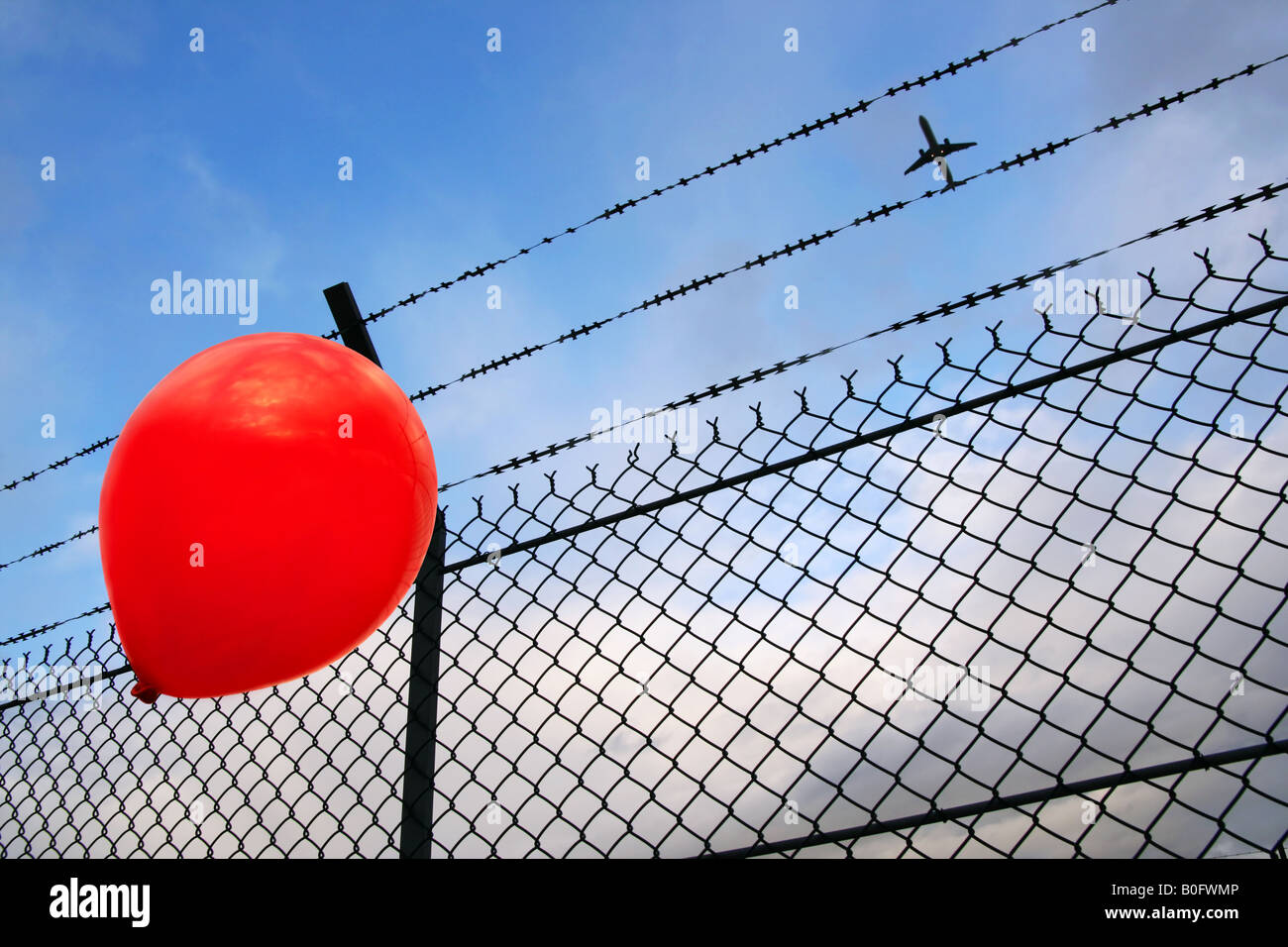 A red balloon in danger Stock Photo