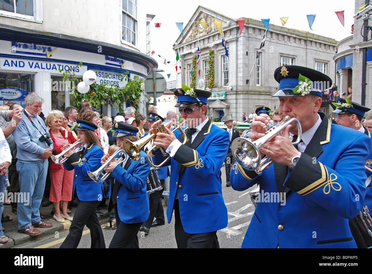 helston town band leading the midday dance on flora day in helston,cornwall,england Stock Photo
