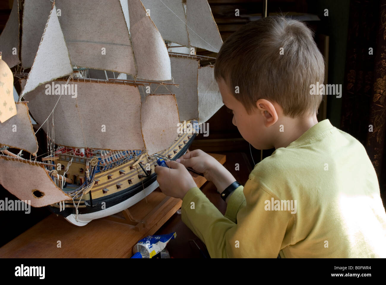 Teen boy building a ship model Le Solei Royal Stock Photo