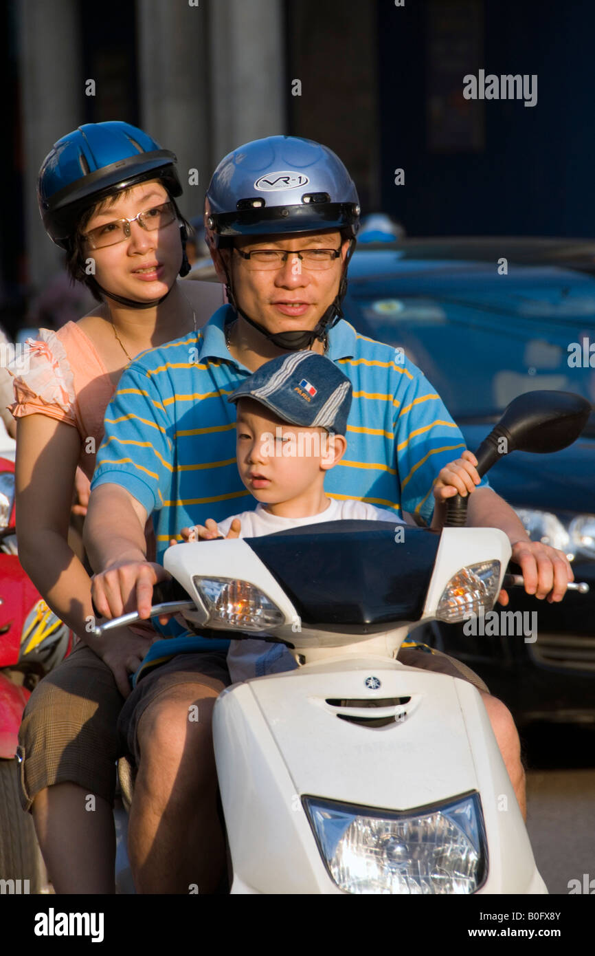 Family on a scooter on Trang Tien, Hanoi, Vietnam Stock Photo