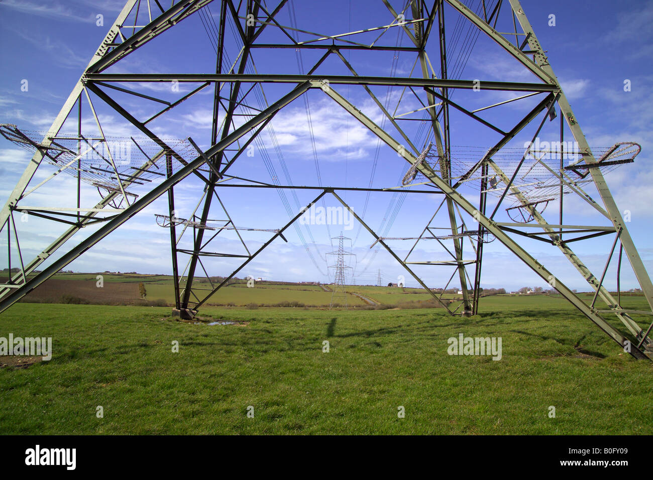 Electricity pylons against a blue sky Stock Photo - Alamy