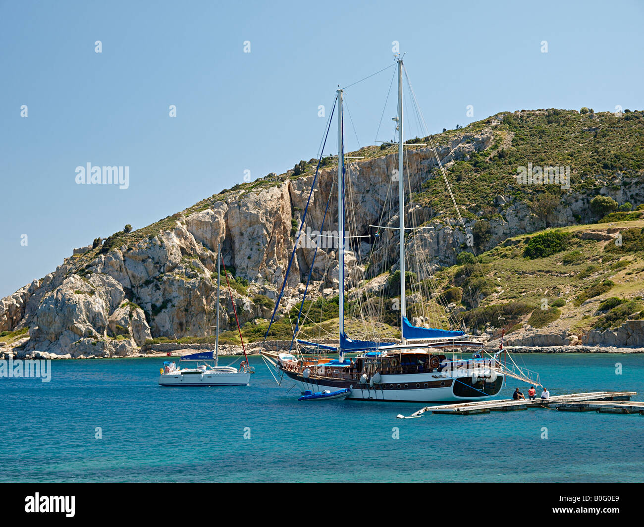 HARBOUR WITH GULET AND OTHER MOORED SAILING BOATS AT KNIDOS, DATCA PENINSULA MUGLA TURKEY Stock Photo