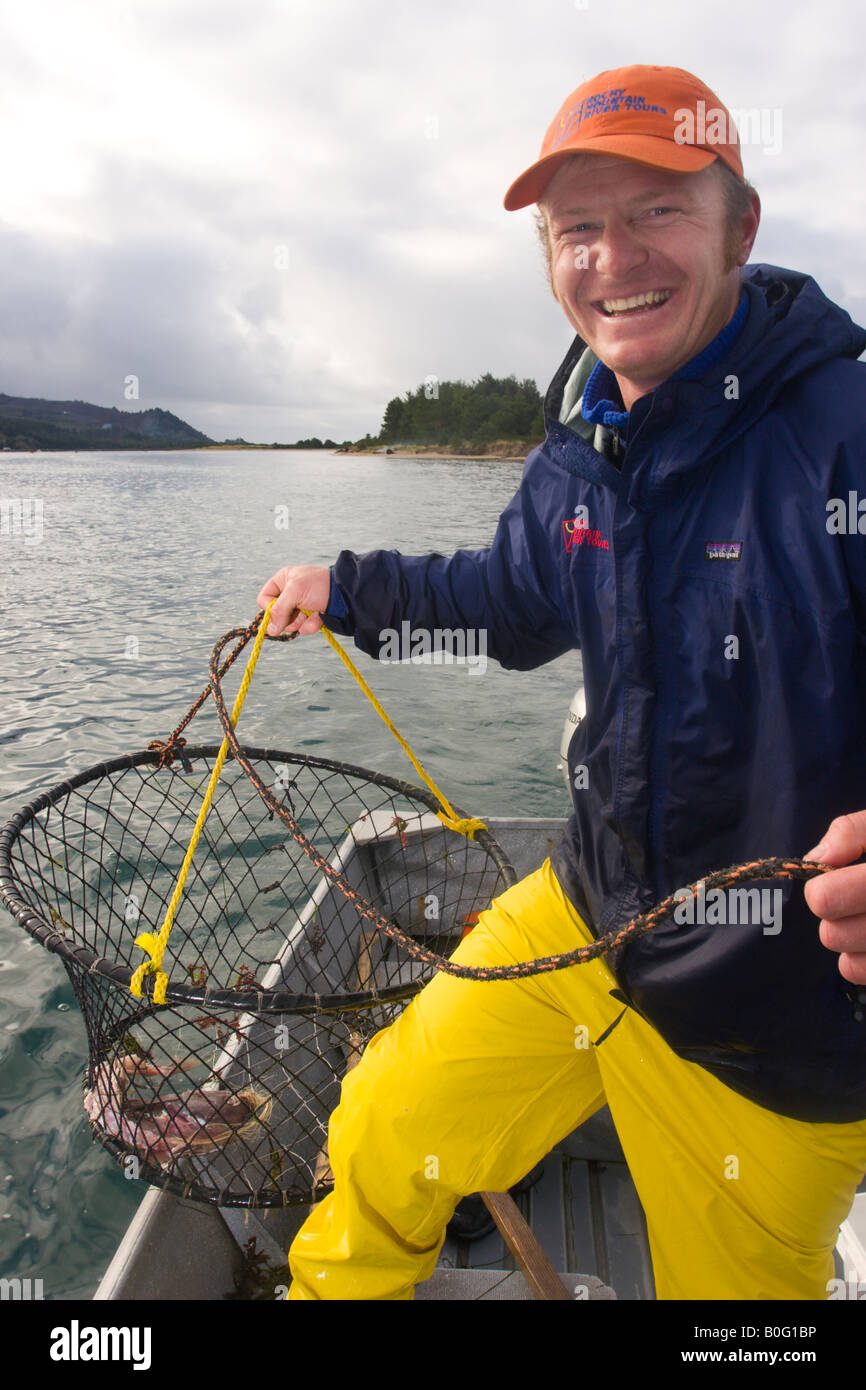 North America Oregon Coast Bayview Crab fishing man pulls crab pot back