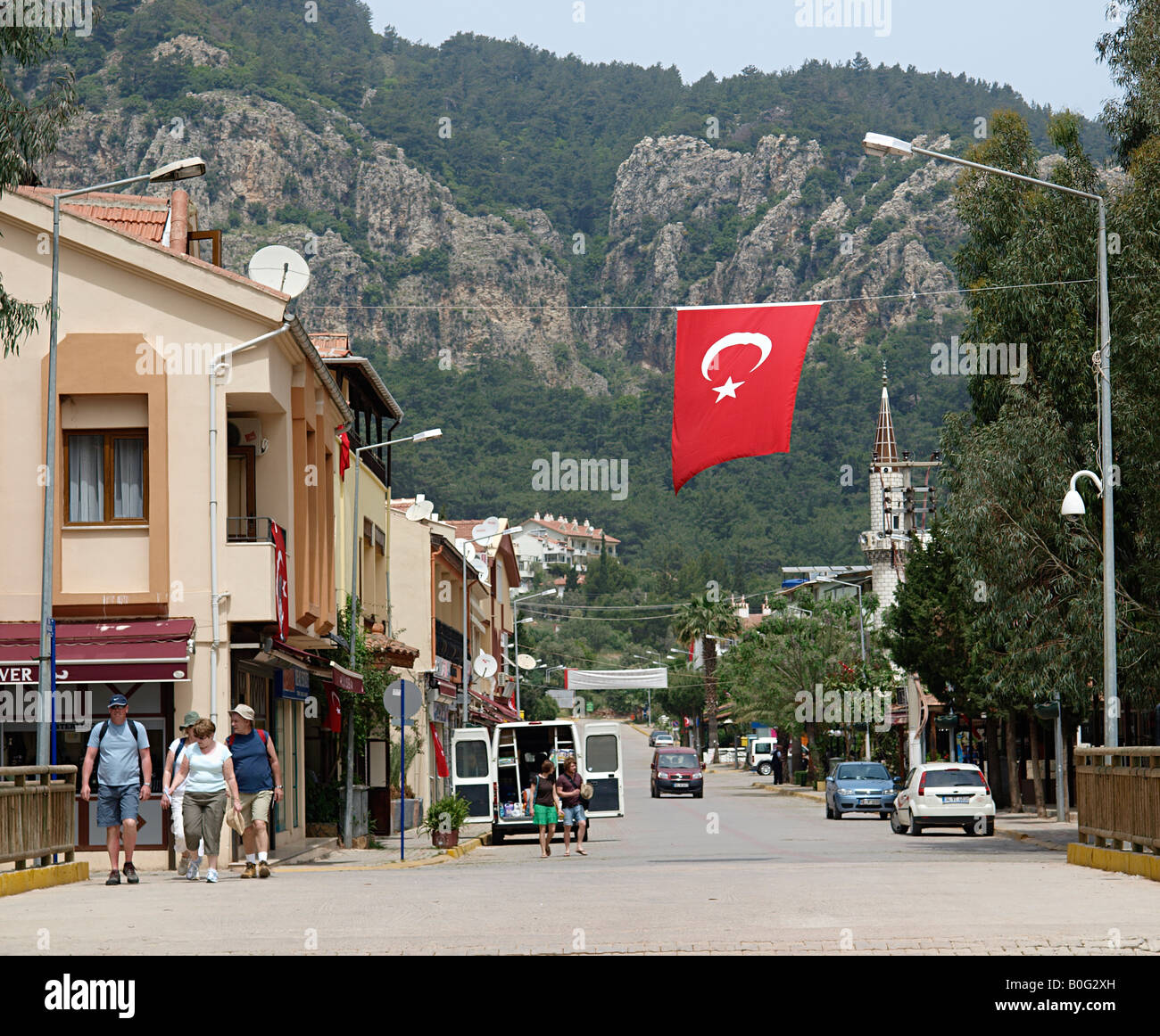 MAIN STREET TURUNC WITH TURKISH FLAG AND MOSQUE, ,  MUGLA TURKEY Stock Photo