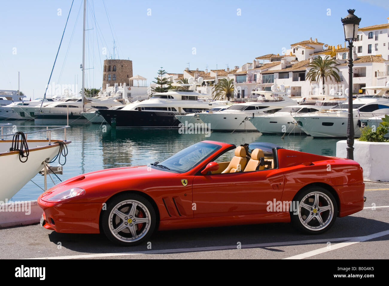 Marbella Costa del Sol Malaga Province Spain Puerto Jose Banus Red Ferrari parked on port side Stock Photo