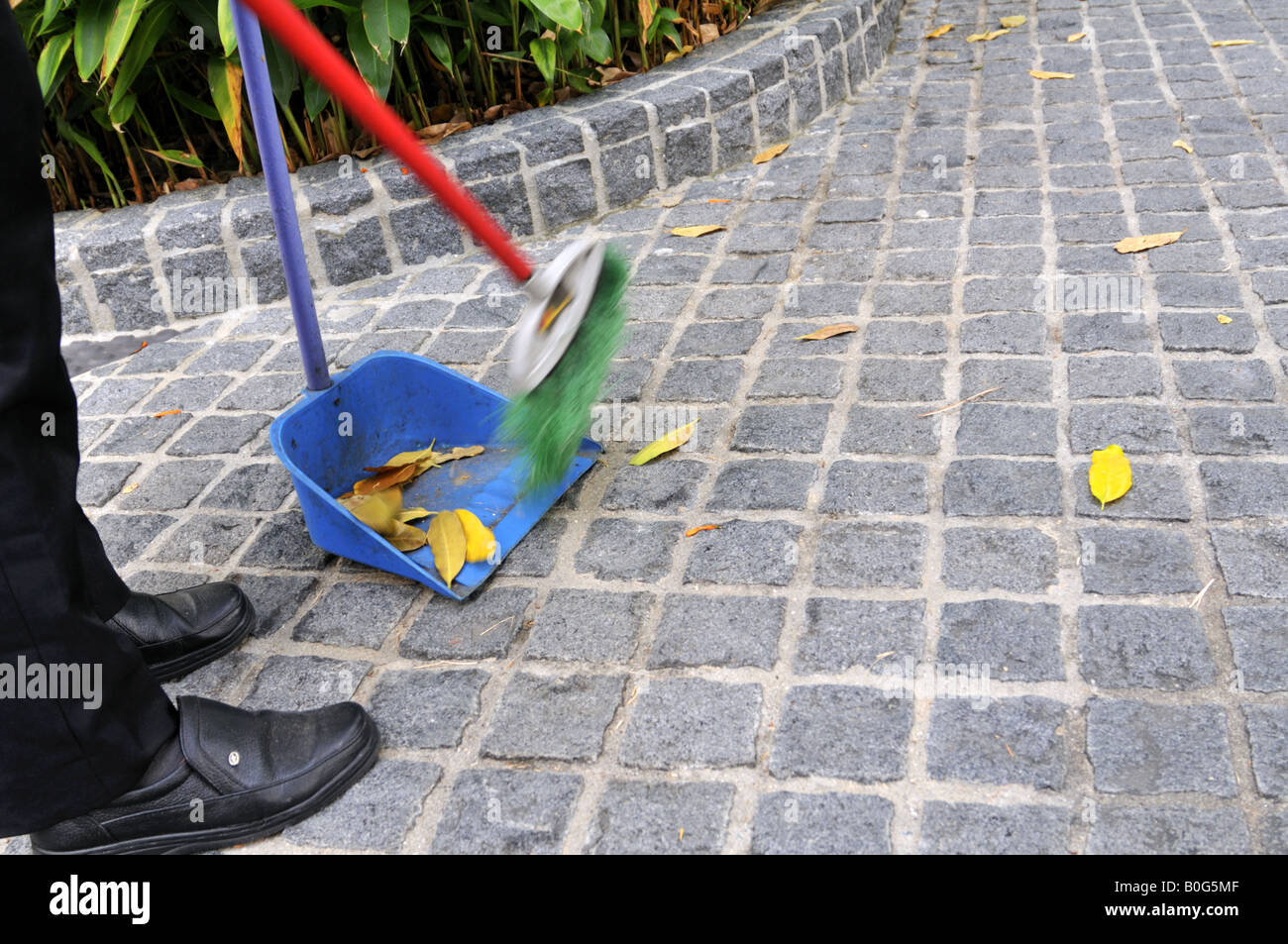 Man sweeping street hires stock photography and images Alamy