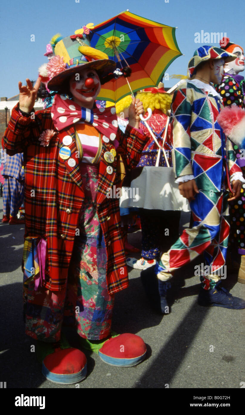 brightly dressed waving clown at the last bognor clowns convention bognor regis england uk Stock Photo