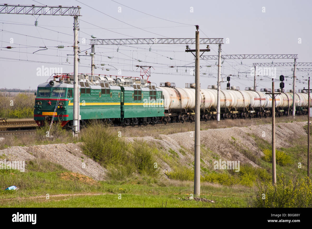 Russian freight train with electric locomotive pulling oil tankers, near Volgograd, Russia, Russian Federation Stock Photo