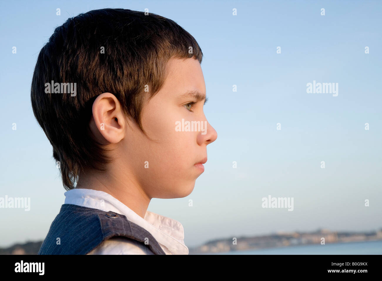 Young boy looking out to sea Stock Photo