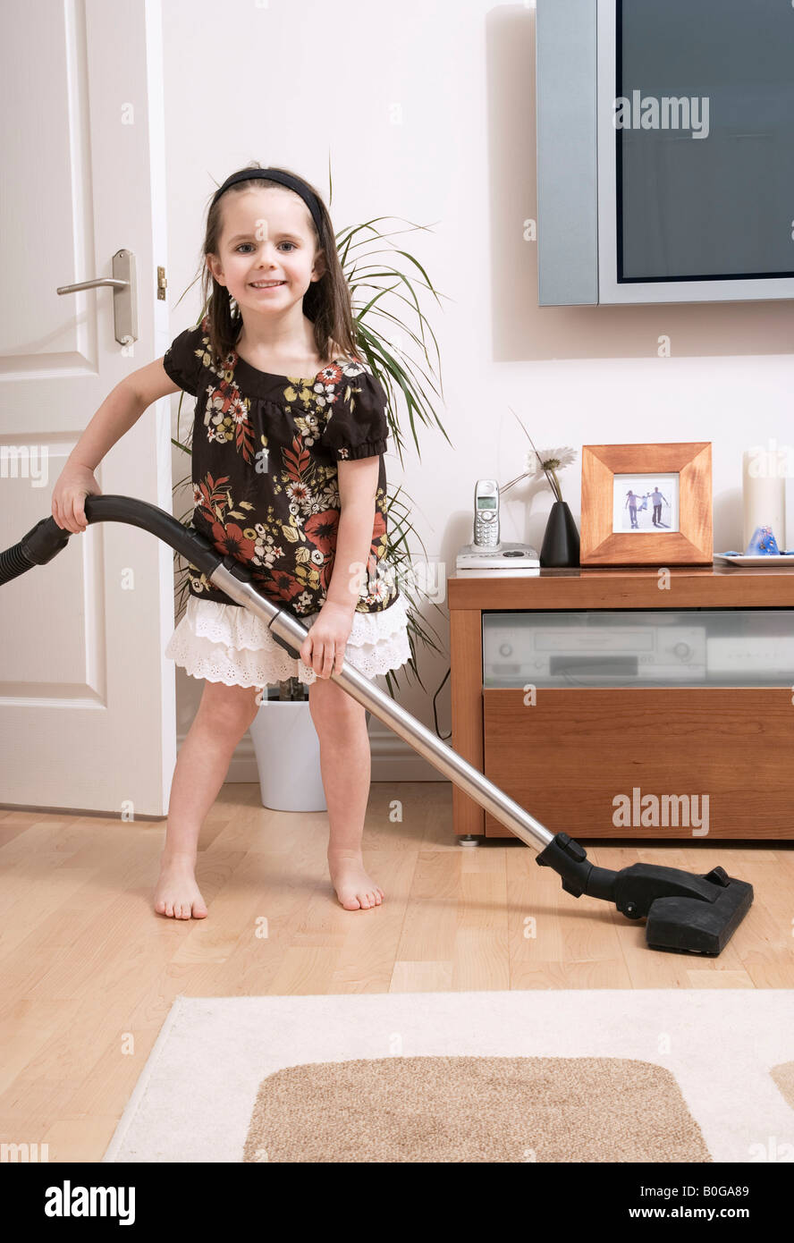 Young girl doing housework Stock Photo