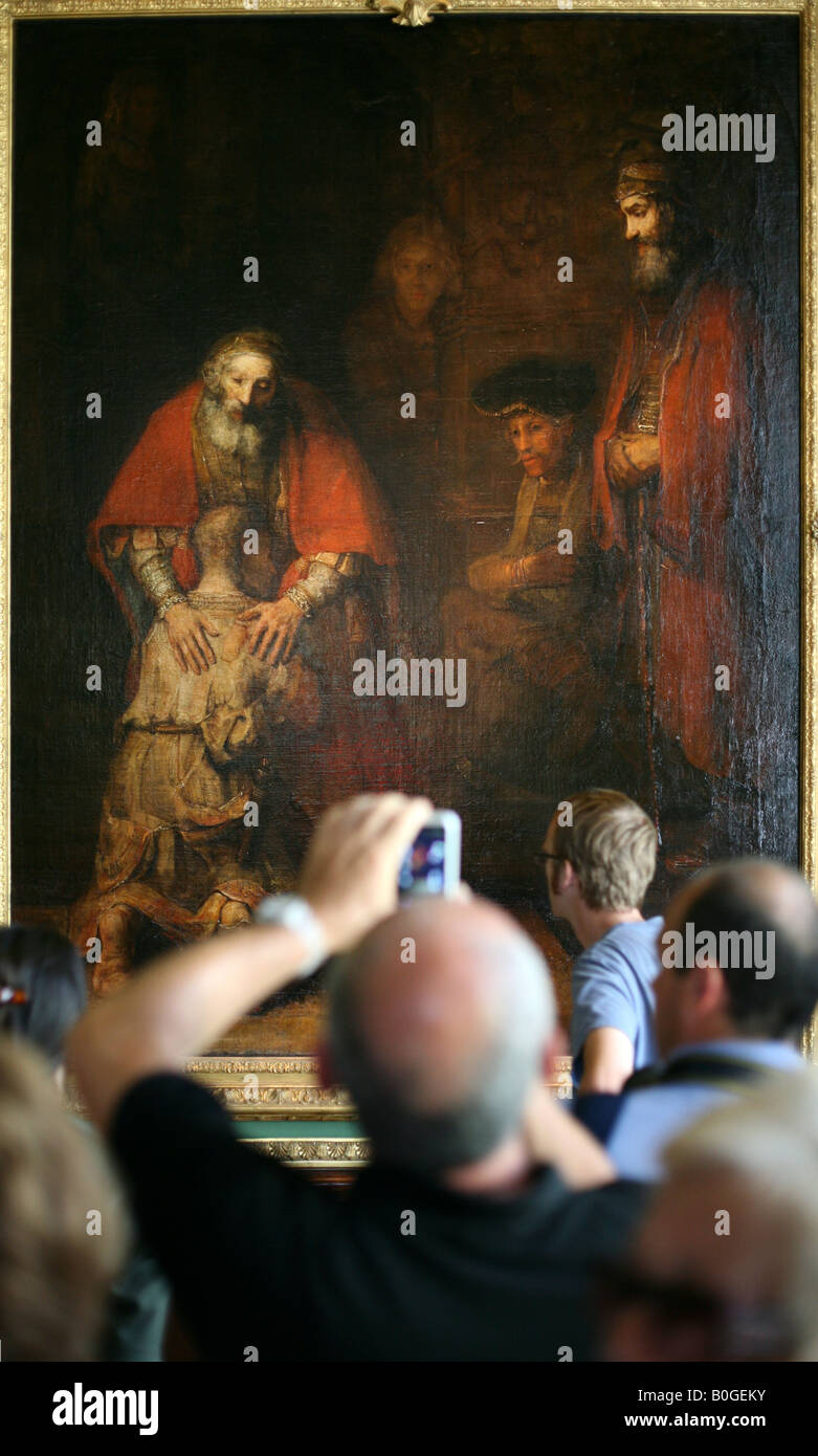 Visitor taking photo of the famous painting by Rembrandt 'The Return of the Prodigal Son' in the Hermitage Museum, Russia Stock Photo