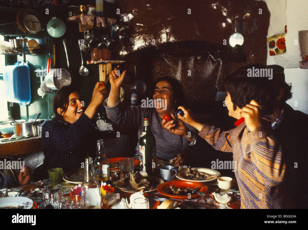 A family cracking red eggs at an Easter Sunday celebration, Pathos