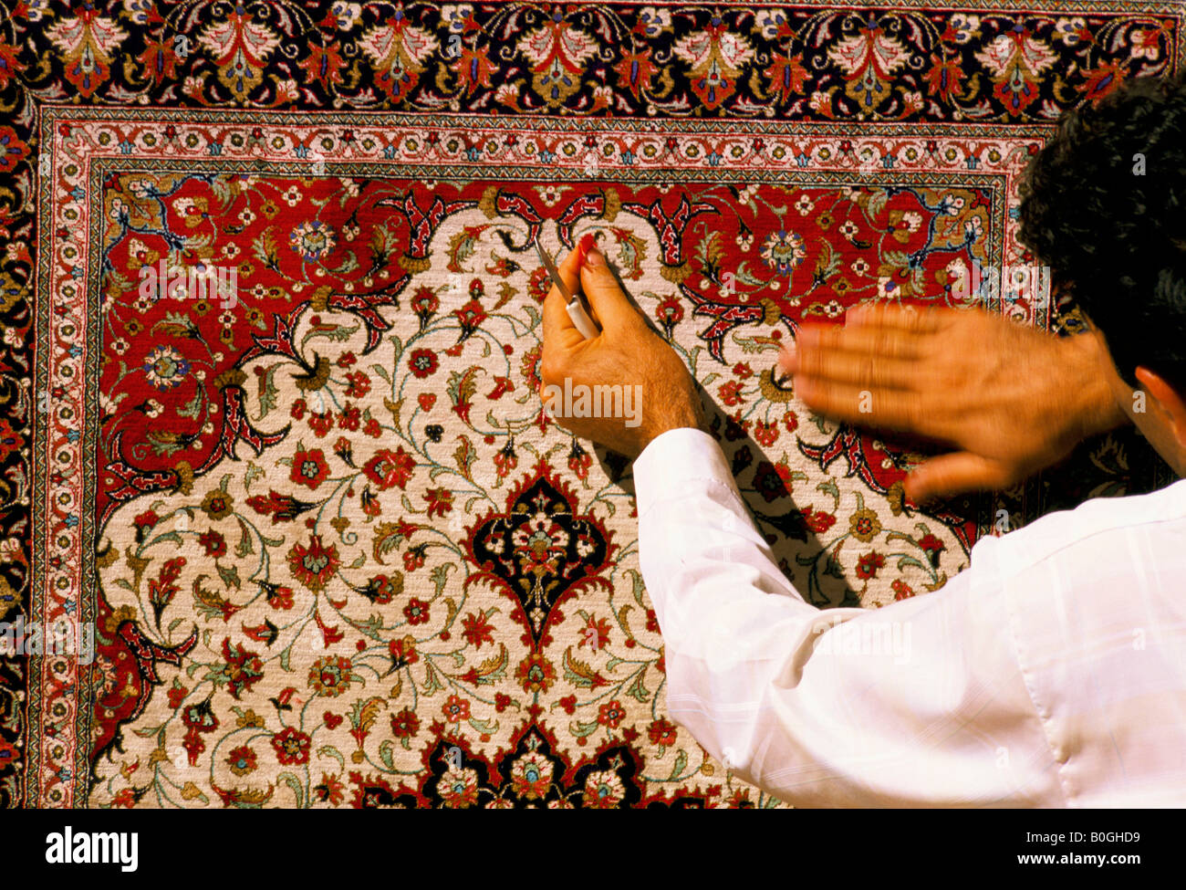 A man making a Persian carpet, Qom, Iran. Stock Photo