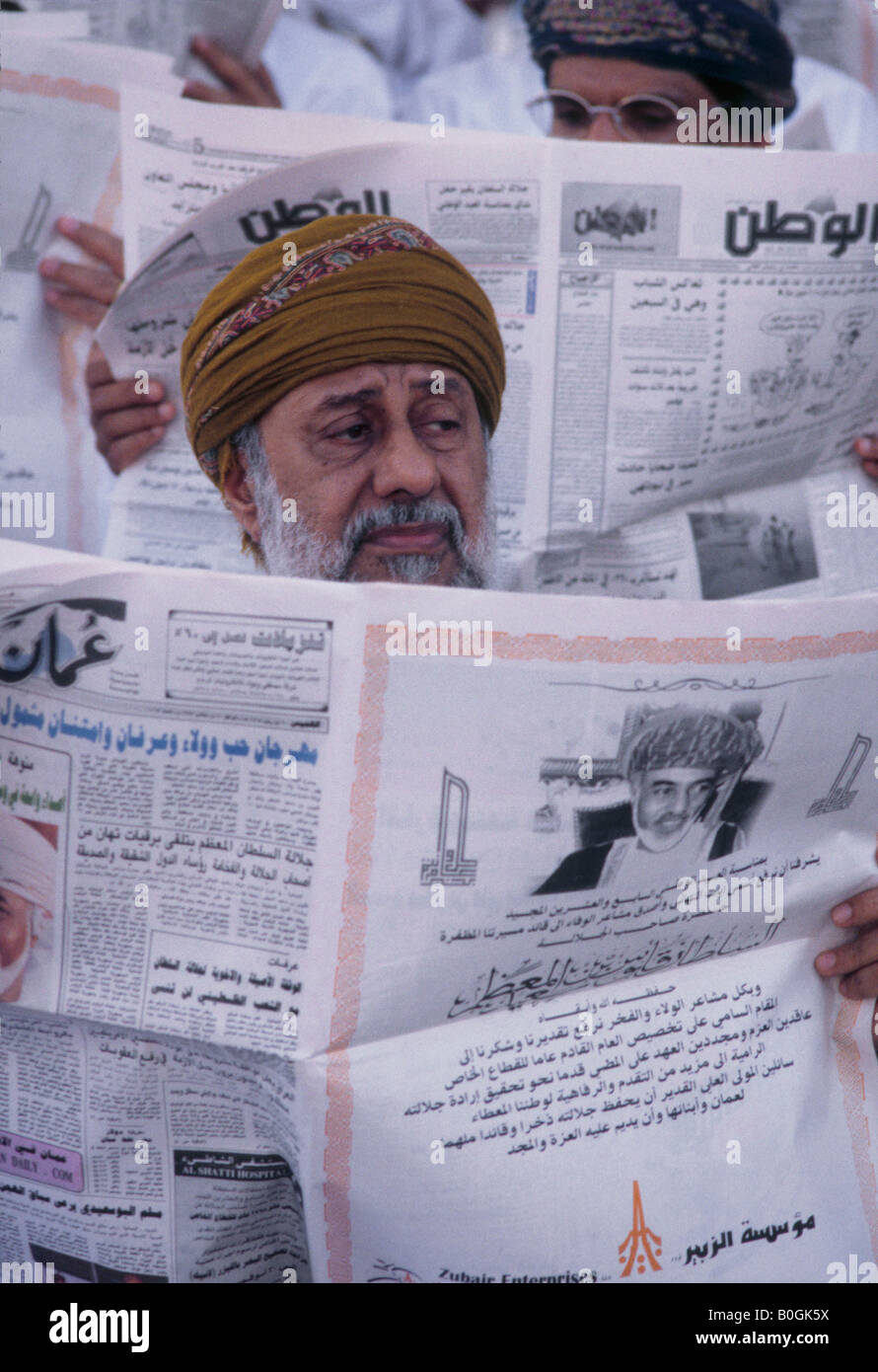 A man reading a newspaper, Oman Stock Photo Alamy