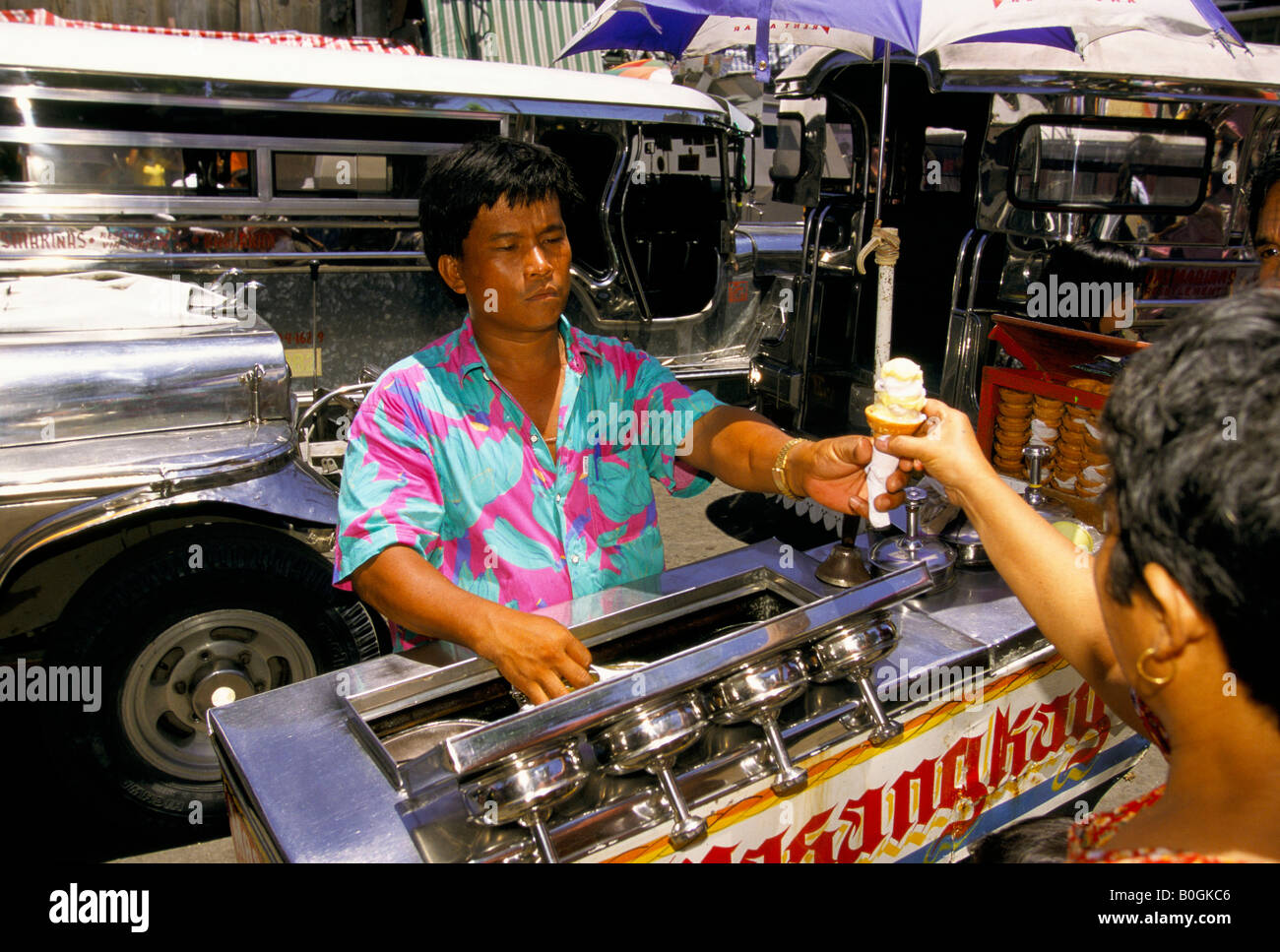 A man selling ice cream from a cart on the street, Manila, Philippines