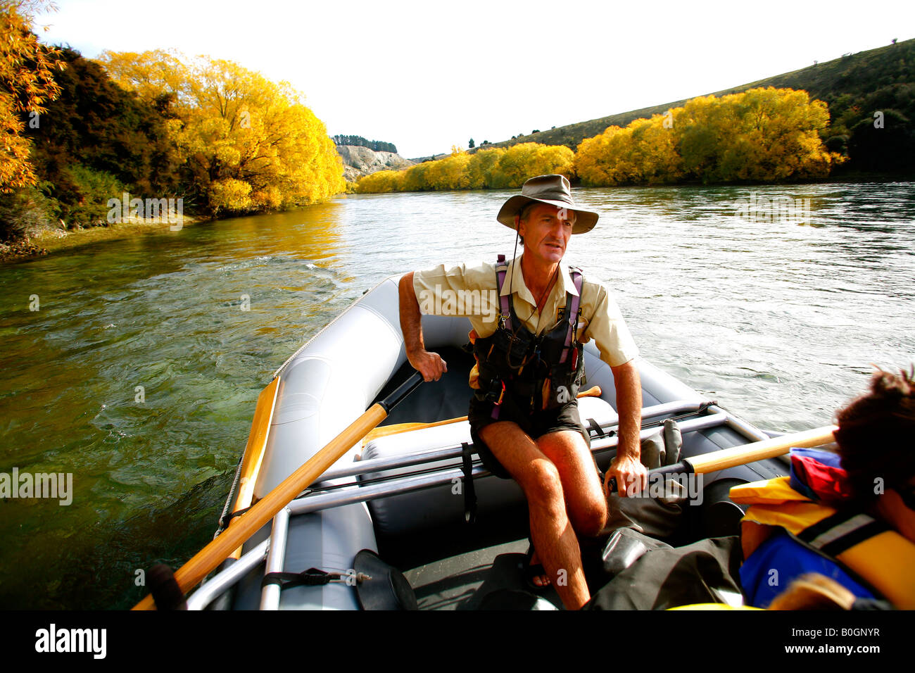 Lewis Verdun of Pioneer Rafts guides his Avon inflatable down the Clutha river in Central Otago New Zealand Stock Photo