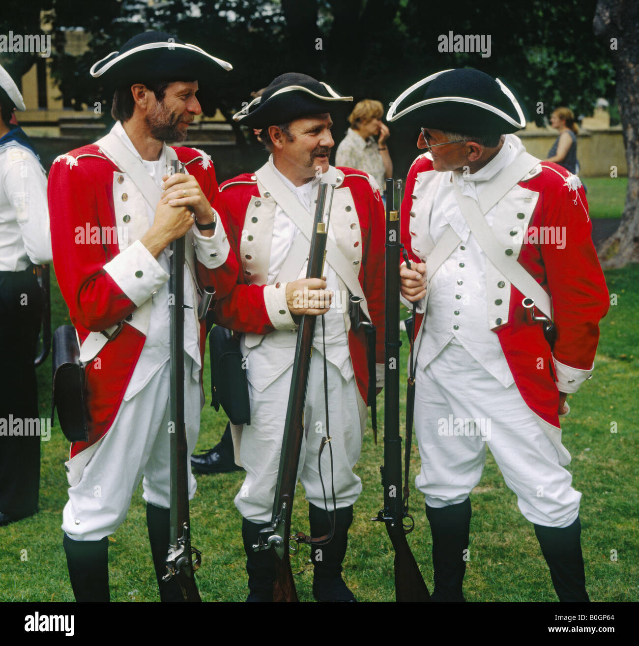 Three men in red and white uniforms and black & white tricorn hats as early British soldiers in St David’s Park Hobart Tasmania Stock Photo