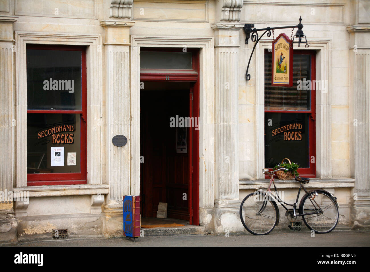 An elegant ladies bicycle outside a second hand book shop in Oamaru New Zealand Stock Photo