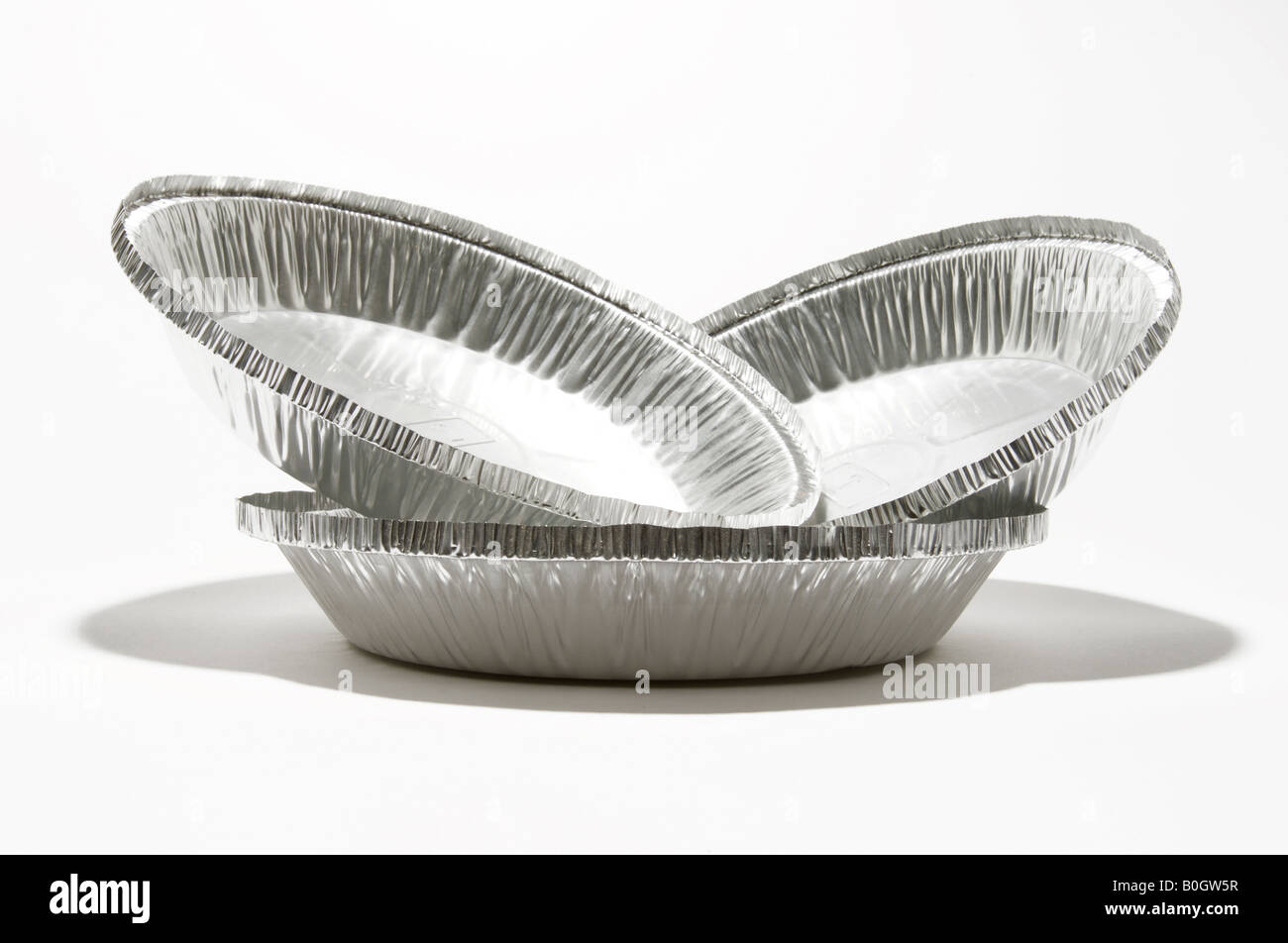 Three stacked aluminum metal containers on a white background. Stock Photo