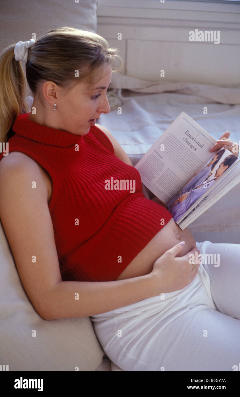pregnant woman reading a book Stock Photo