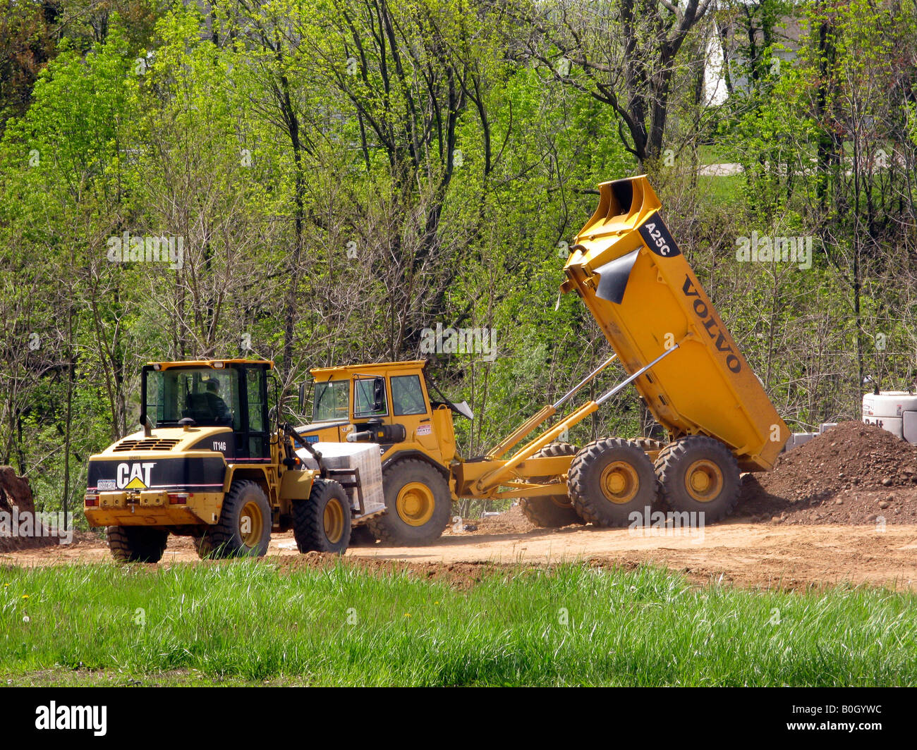 Articulated dump truck emptying load Stock Photo Alamy