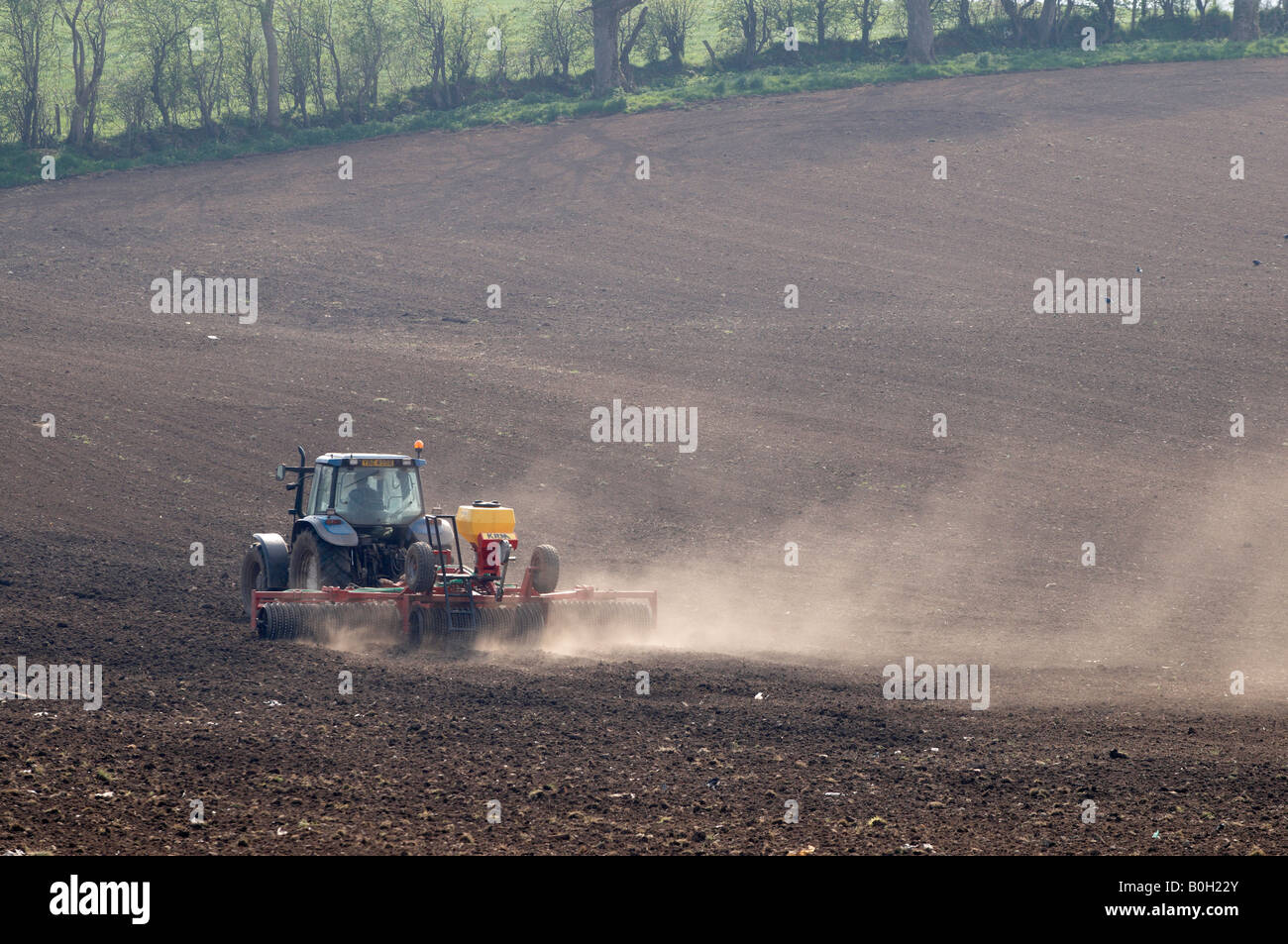 Tractor working dry arid ground Stock Photo Alamy