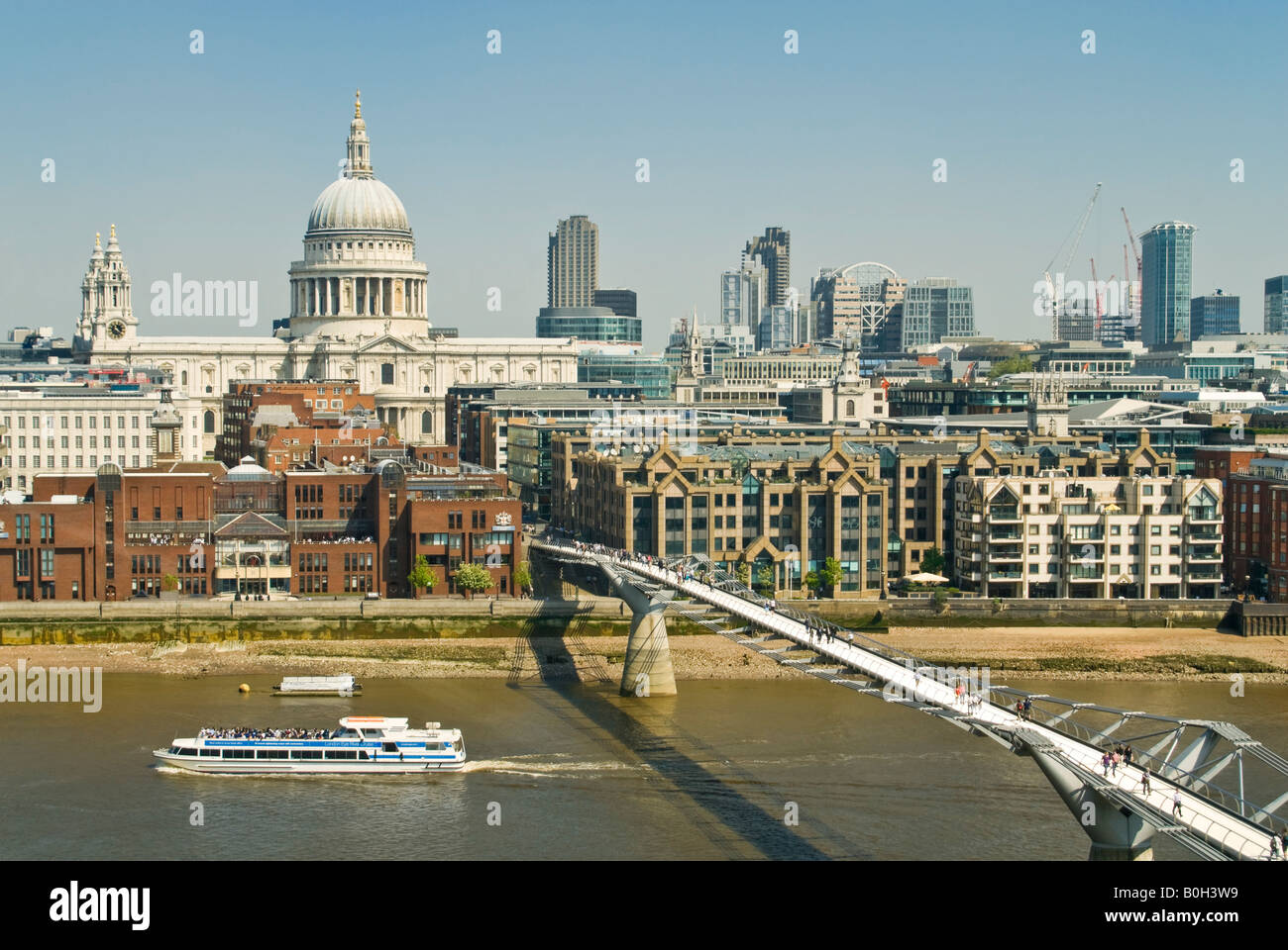 Horizontal aerial view over London of St Paul's Cathedral and the Millennium Bridge (aka Wobbly Bridge) on a bright sunny day. Stock Photo