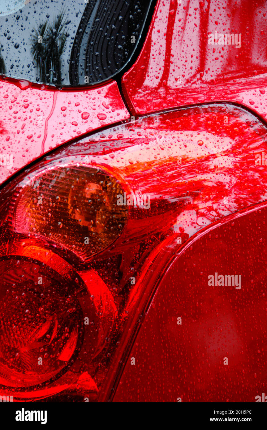 Red brake light, raindrops, Suzuki Swift Stock Photo Alamy